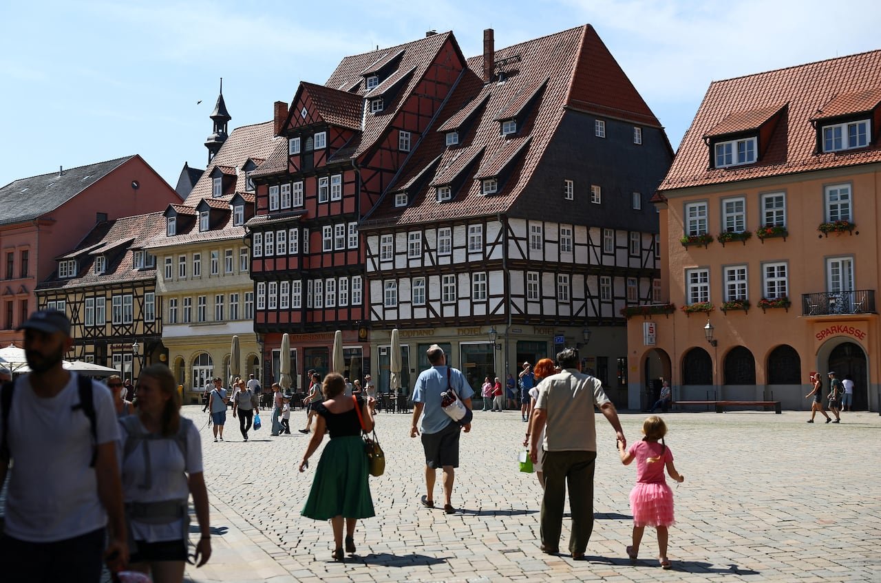 default-427 A general view of the historical central plaza with its historic half-timbered construction in Quedlinburg, Saxony-Anhalt, Germany, August 4, 2026. Studies suggest the AfD's rise is fuelled by a lingering sense of economic disadvantage, 36 years afte